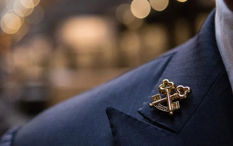 Clefs d'Or logo button on jacket collar